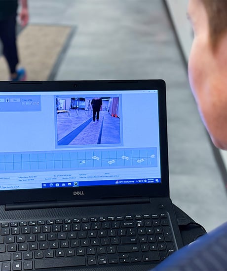 Grasshopper Health Researcher Looking at Laptop